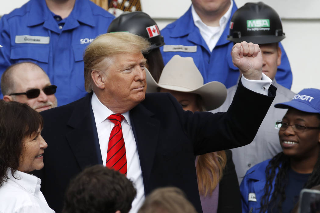 President Donald Trump pumps his fist after signing a new North American trade agreement with C ...