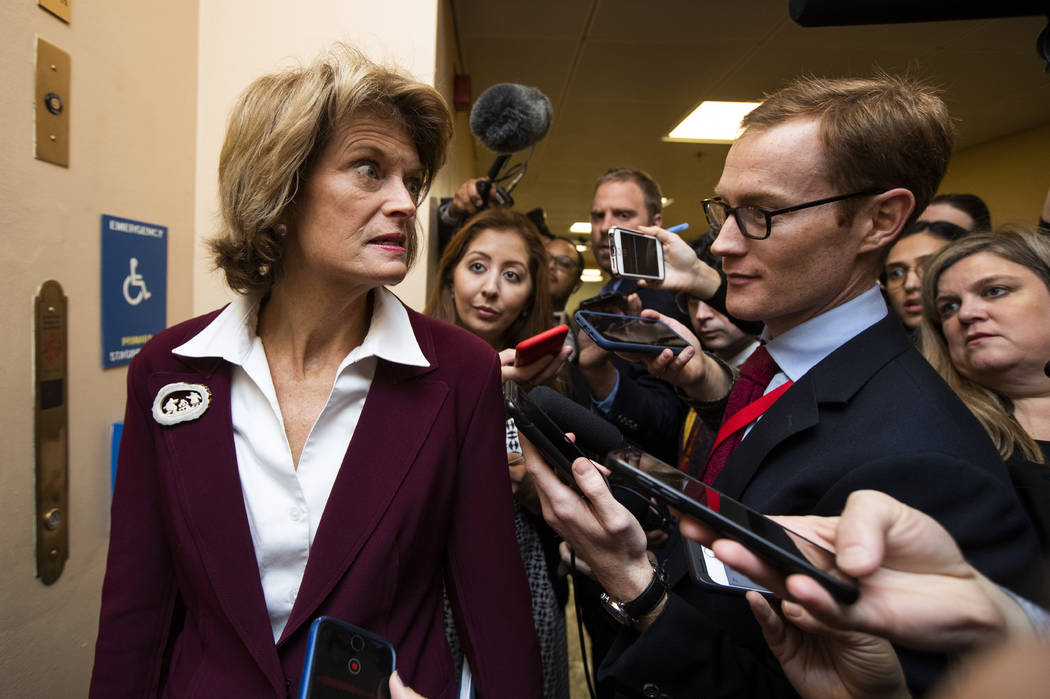 Sen. Lisa Murkowski, R-Alaska., left, talks to reporters at the Capitol in Washington, Tuesday, ...