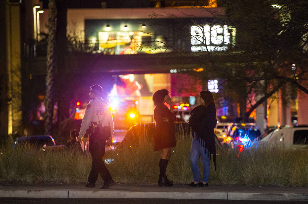 Onlookers watch as the Metropolitan Police Department officers set up with weapons to clear the ...