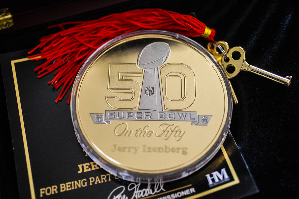 A coin celebrating long-time sports writer Jerry Izenberg's 50th Super Bowl at his home in Hend ...