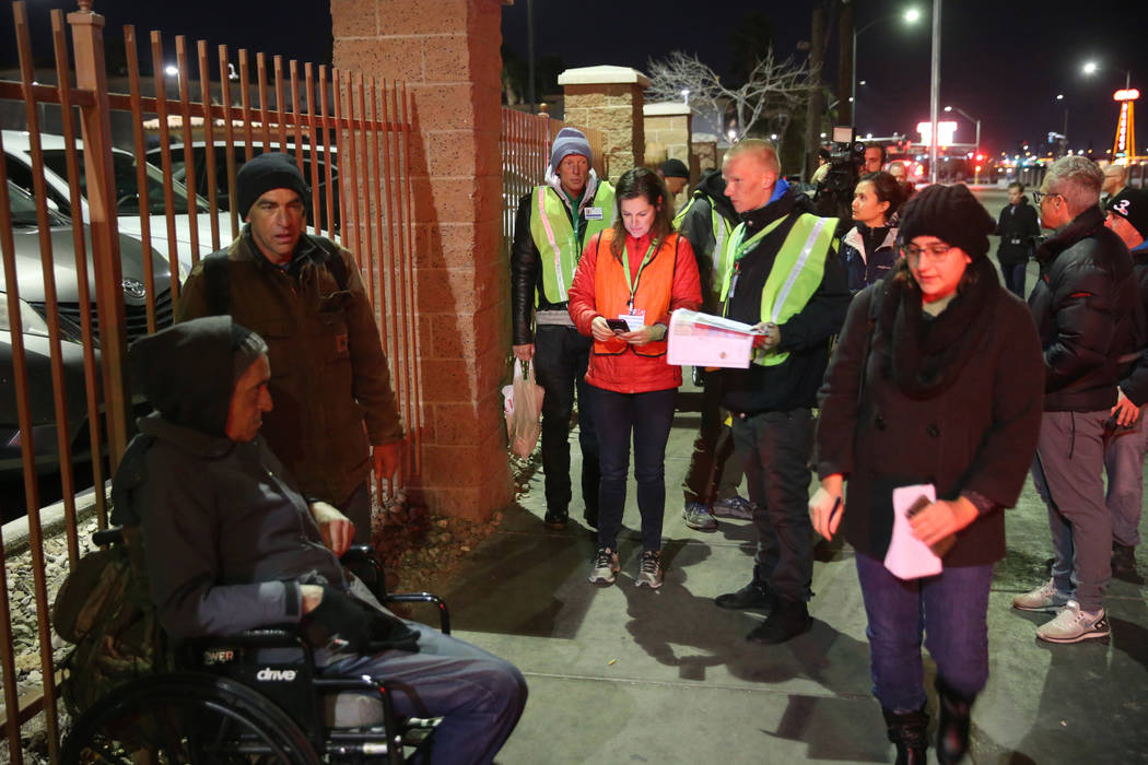 SafeNest CEO Liz Ortenburger, center, uses an app to survey and count the homeless population f ...