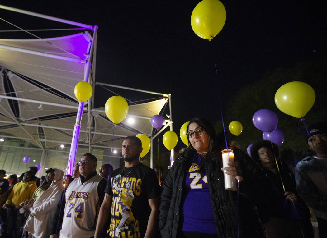 Anabel Hernandez, front/right, Santiago Corona and Anthony Herrera attend a vigil for Kobe Brya ...