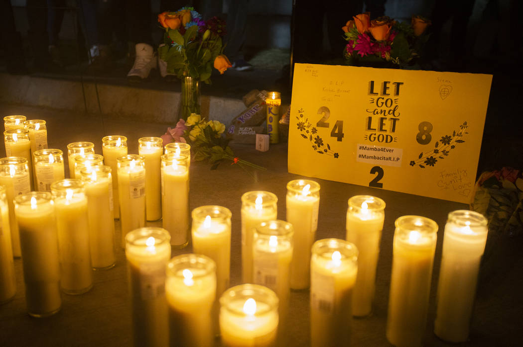 Candles and flowers displayed at a vigil for Kobe Bryant and daughter Gianna who were killed in ...