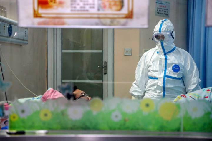 A doctor attends to a patient in an isolation ward at a hospital in Wuhan in central China's Hu ...