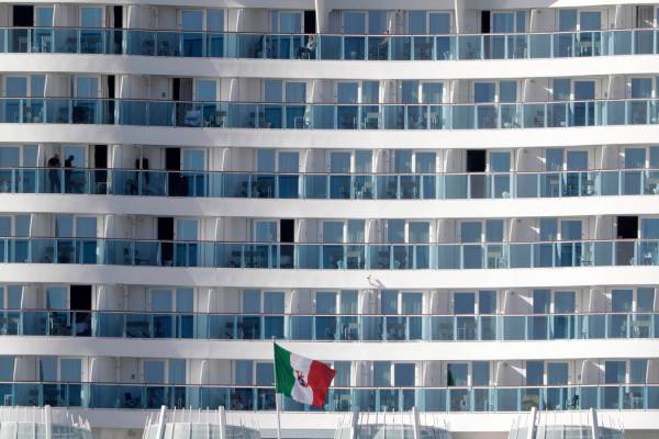 Passengers wait aboard the Costa Smeralda cruise ship, docked in the Civitavecchia port near Ro ...