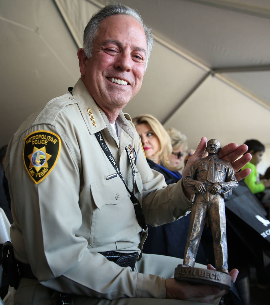 Sheriff Joe Lombardo holds a replica of the Alyn Beck statue he received during the grand openi ...