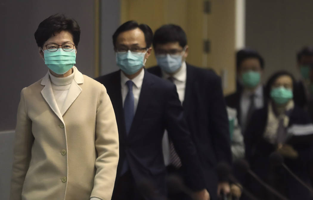 Hong Kong Chief Executive Carrie Lam, front, and other government officials wear protective fac ...