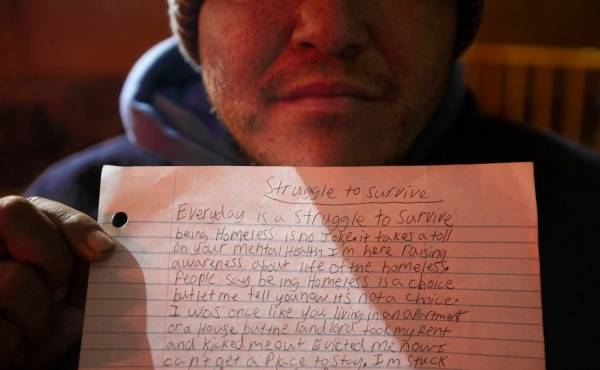 Patrick Wilkey holds a piece of paper chronicling his struggles living on the streets at the Co ...