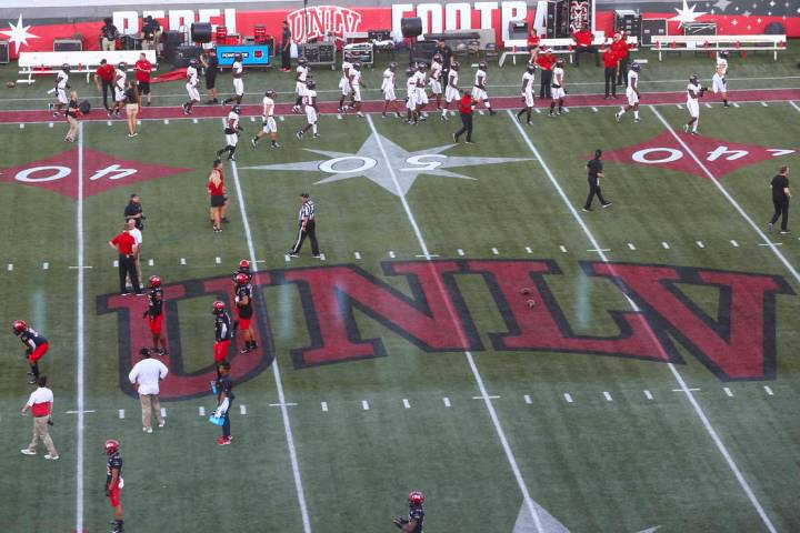 UNLV football players warm up before taking on Arkansas State in an NCAA football game at Sam B ...