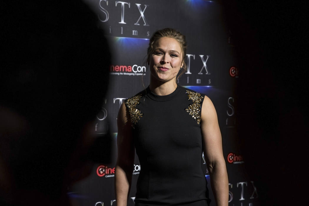 Ronda Rousey takes photos during the STXfilms red carpet event on the second night of CinemaCon ...