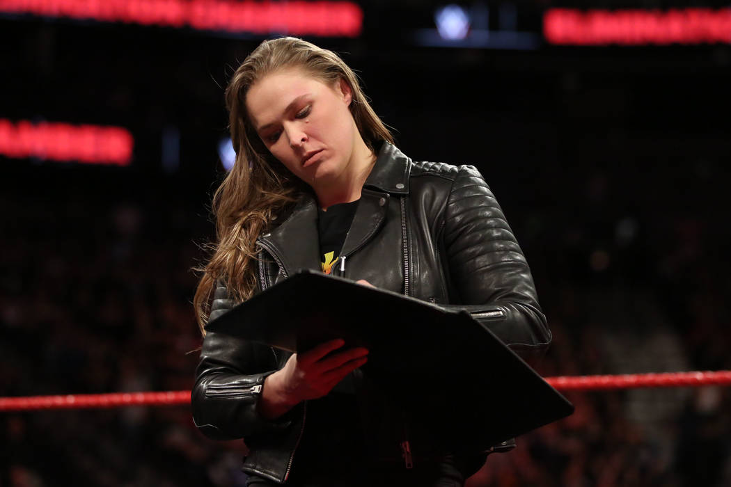Ronda Rousey signed her WWE contract at T-Mobile Arena on Sunday. (WWE)