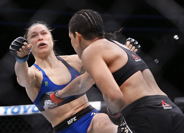 Amanda Nunes lands a strike against Ronda Rousey during their bantamweight championship fight a ...