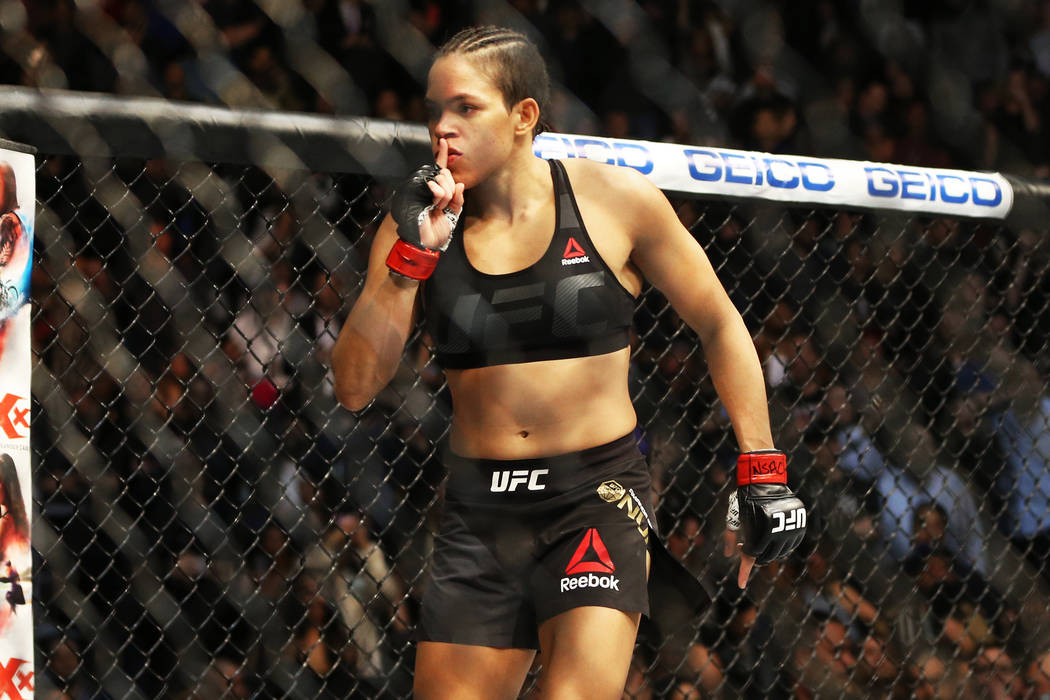 Amanda Nunes celebrates after defeating Ronda Rousey by TKO in the first round during their ban ...