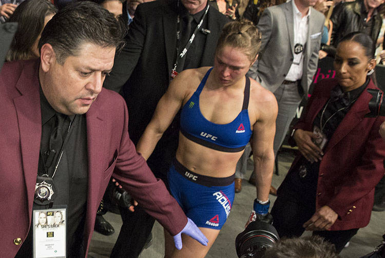 Ronda Rousey walks off stage after being TKO'd by Amanda Nunes during their bantamweight champi ...