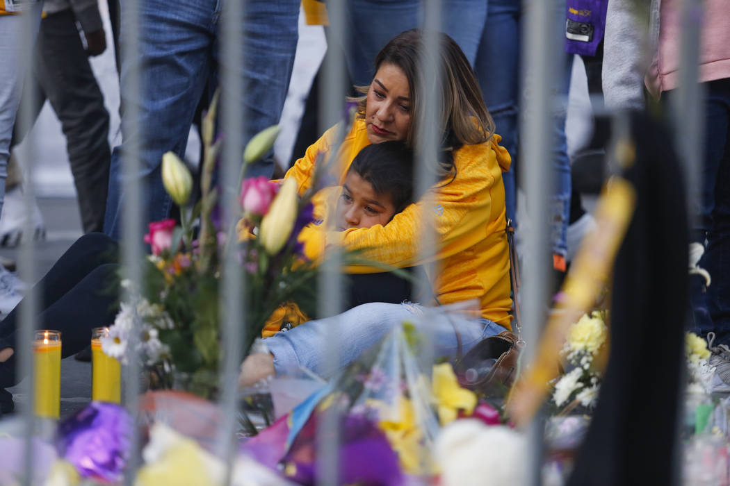 Fans gather to pay their respects at a memorial for the late Kobe Bryant near Staples Center pr ...