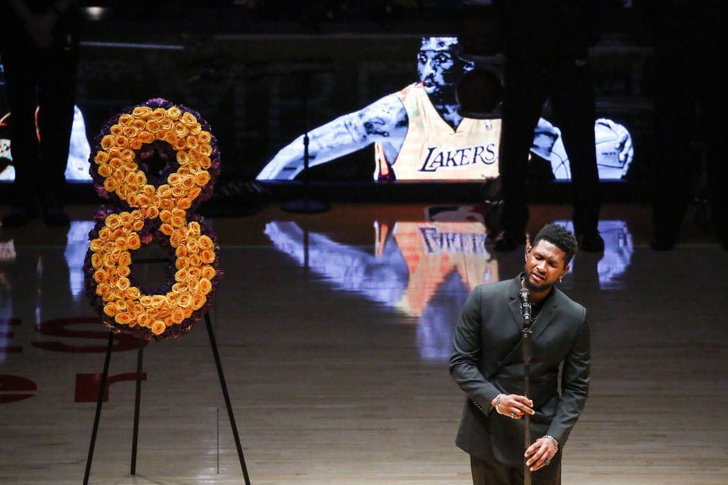 Singer Usher performs during a memorial prior to an NBA game between the Los Angeles Lakers and ...