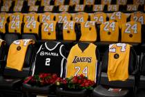 The jerseys of late Los Angeles Laker Kobe Bryant, right, and his daughter Gianna are draped on ...