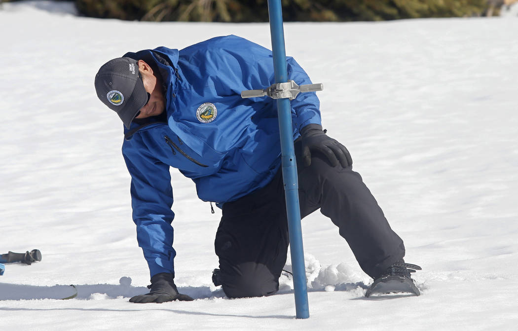Sean de Guzman, chief of snow surveys for the California Department of Water Resources, checks ...