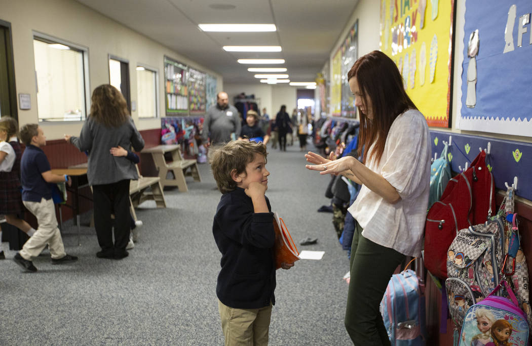First grade teacher Nicole Doney, right, speaks to student Tristan Boaz before reading groups a ...