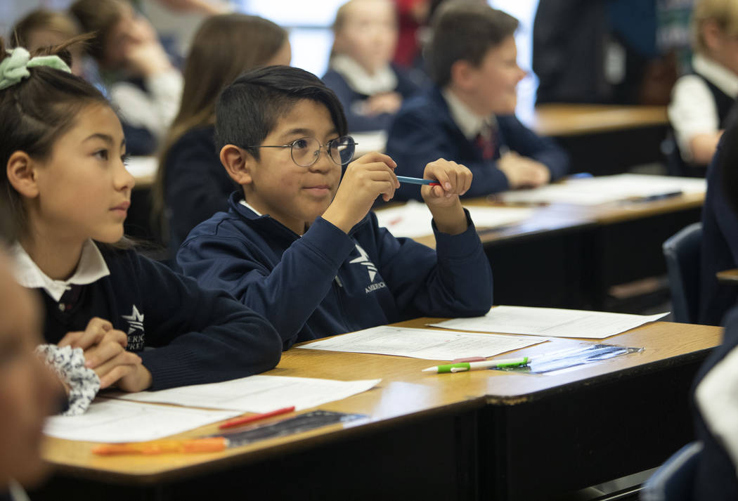 Michael Bonilla, center, pays attention to his teacher at American Preparatory Academy on Thurs ...
