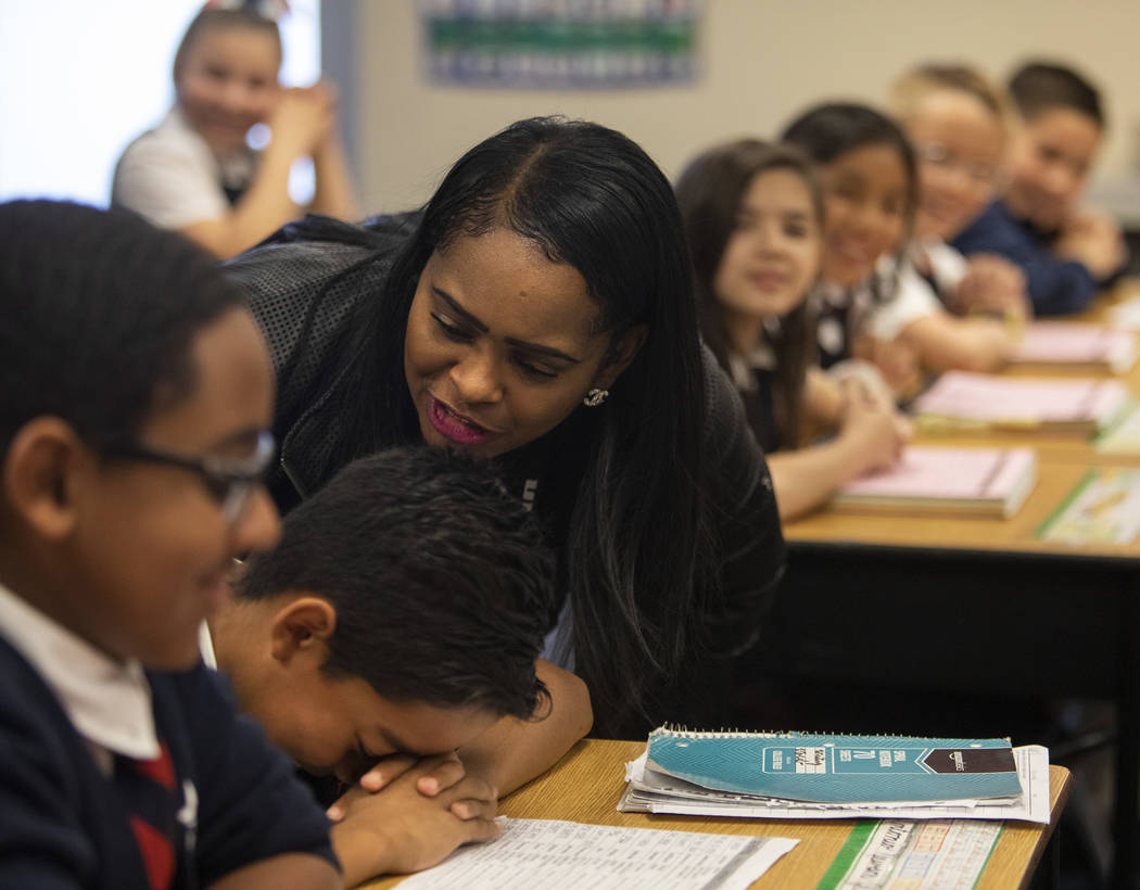 Lusha' Carter reprimands one of her fifth grade students for goofing off during class at Americ ...