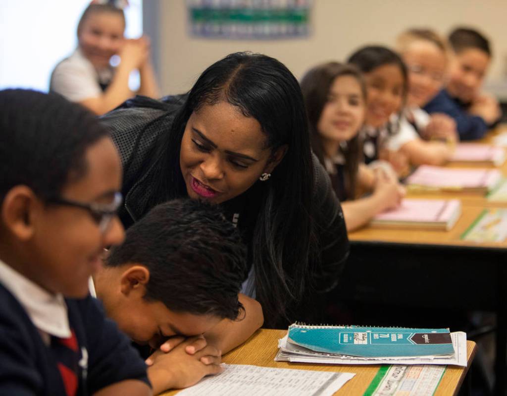 Lusha' Carter reprimands one of her fifth grade students for goofing off during class at Americ ...