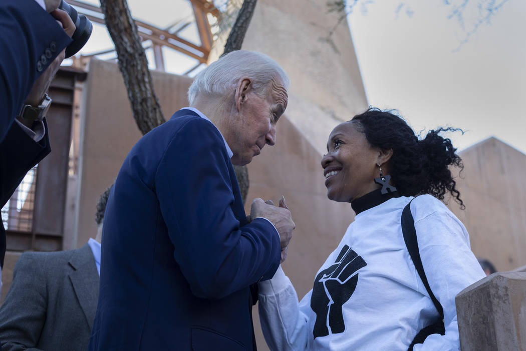 Former Vice President Joe Biden speaks with Sharon Burton as he campaigns at the Black History ...