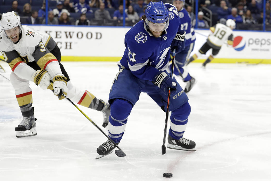Tampa Bay Lightning center Brayden Point (21) loses the puck to a stick-check by Vegas Golden K ...