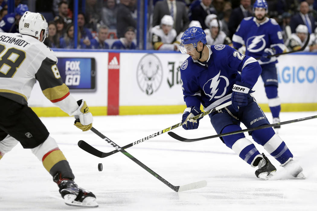 Tampa Bay Lightning defenseman Kevin Shattenkirk (22) tries to control a bouncing puck in front ...