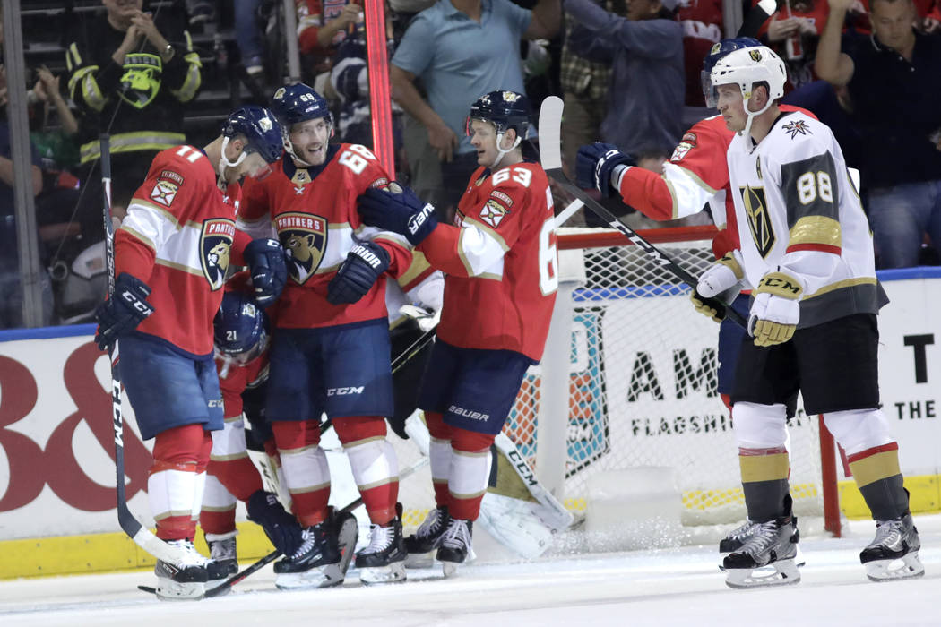 Florida Panthers left wing Mike Hoffman (68) celebrates with left wing Jonathan Huberdeau (11) ...