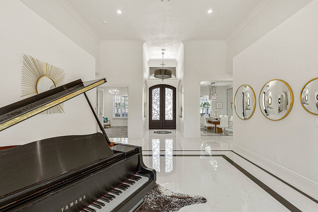 The living room has a piano. (Red Luxury Real Estate)
