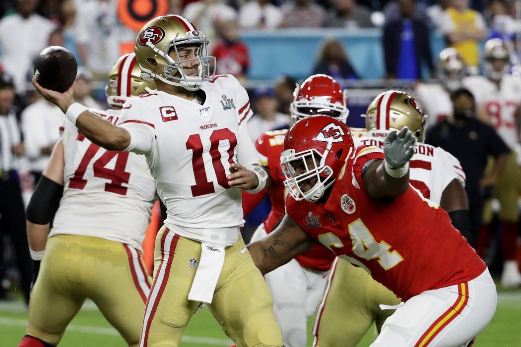 Kansas City Chiefs' Damien Williams, second from right, is tackled against the San Francisco 49 ...