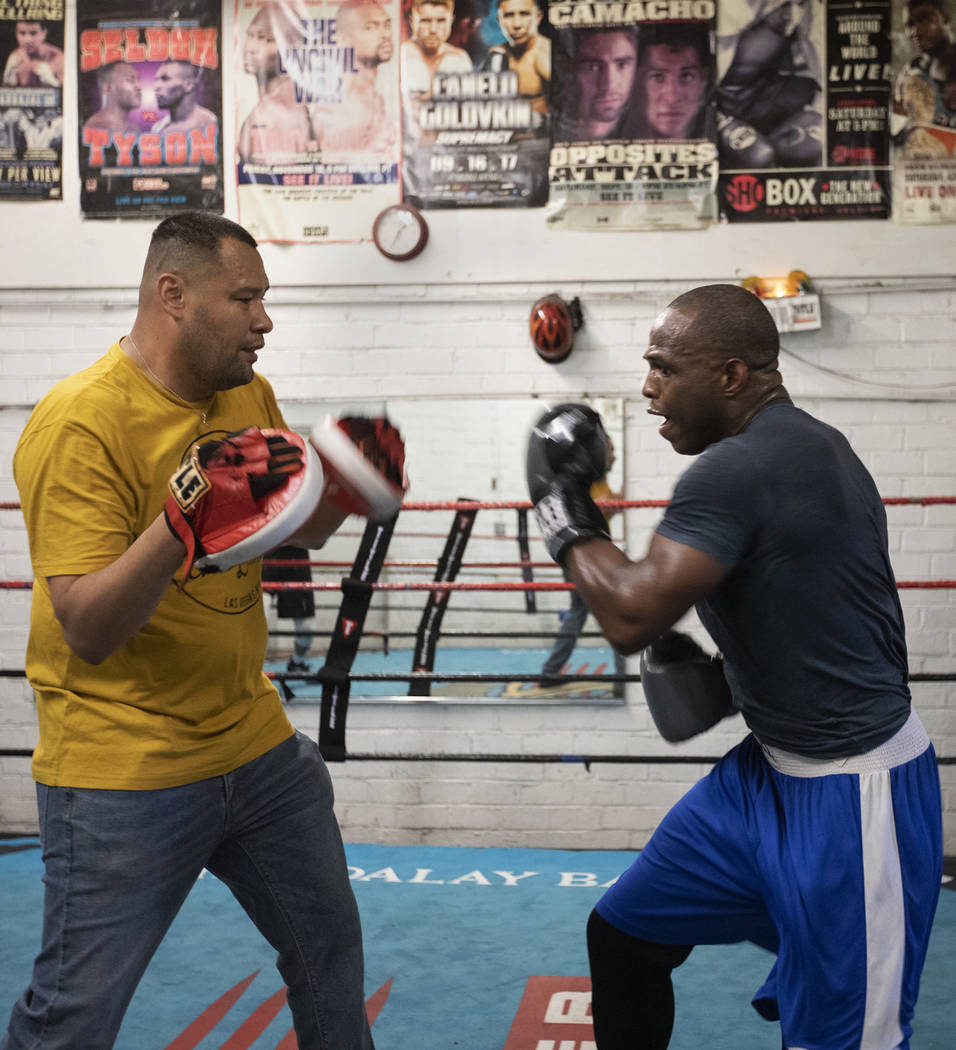 Heavyweight boxer Rubens Nicolas, right, boxes with private trainer Eddie Sanchez, left, on Fri ...