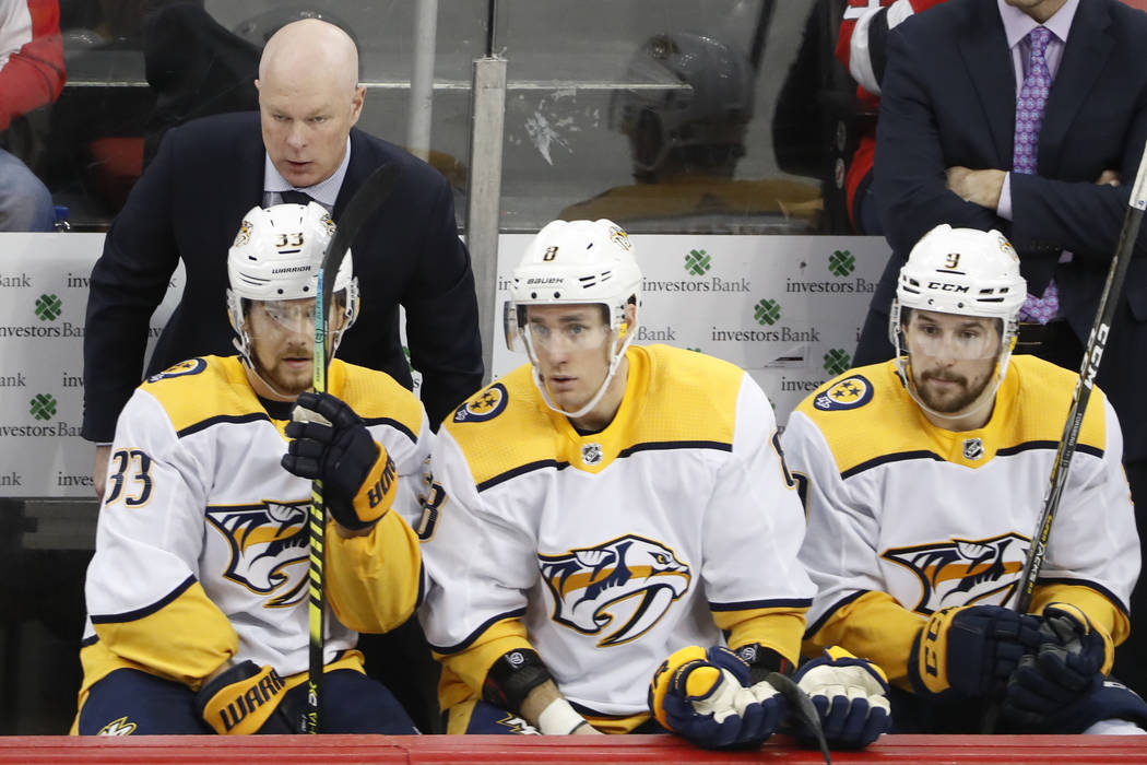 Nashville Predators head coach John Hynes, upper left, leans in to his players during a timeout ...