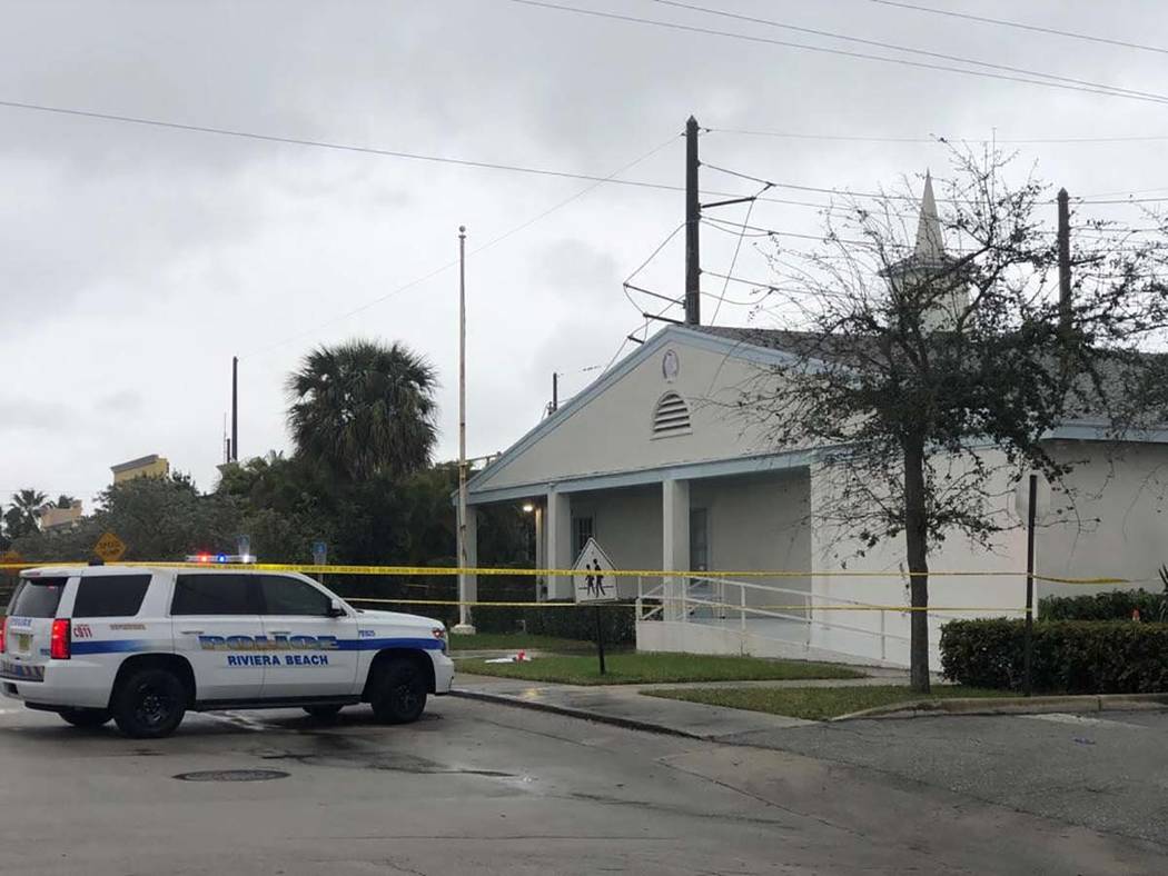 Law enforcement officials stand guard outside the Victory City Church in Riviera Beach, Fla., o ...