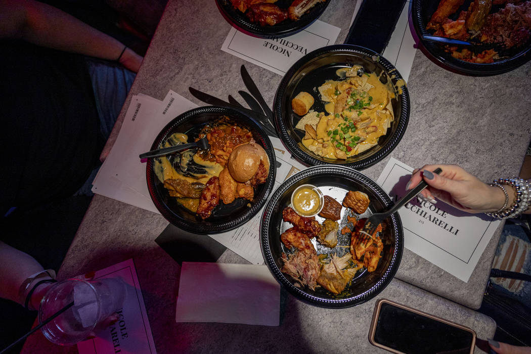 People eat while attending a Super Bowl watch party at the HyperX Esports Arena Las Vegas at th ...