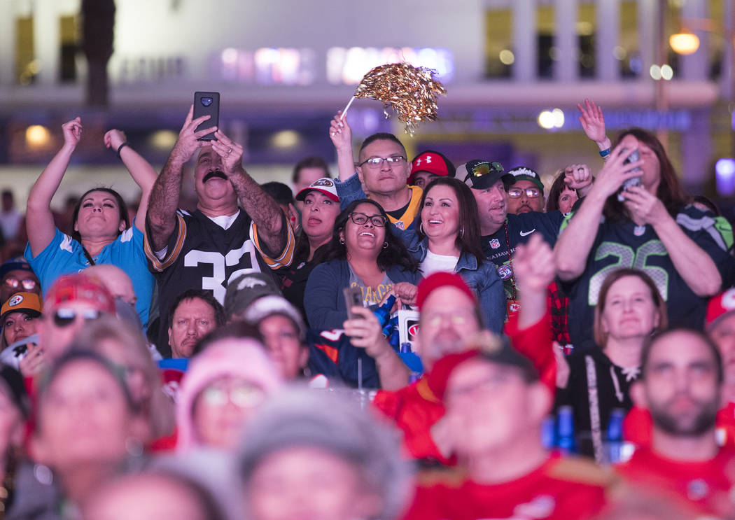 The crowd cheers for the half time show at a watch party for Super Bowl LIV at the Downtown Las ...