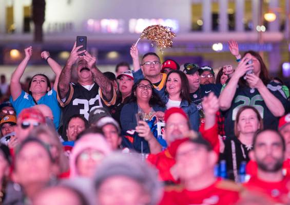The crowd cheers for the half time show at a watch party for Super Bowl LIV at the Downtown Las ...