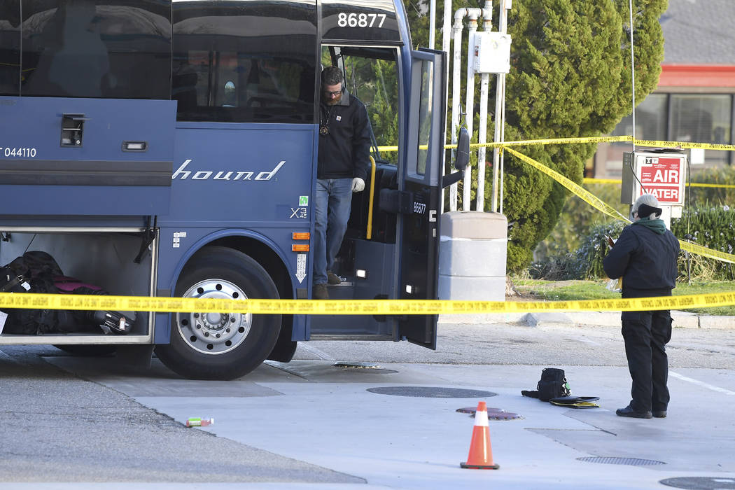 Investigators are seen outside of a Greyhound bus after a passenger was killed on board on Mond ...