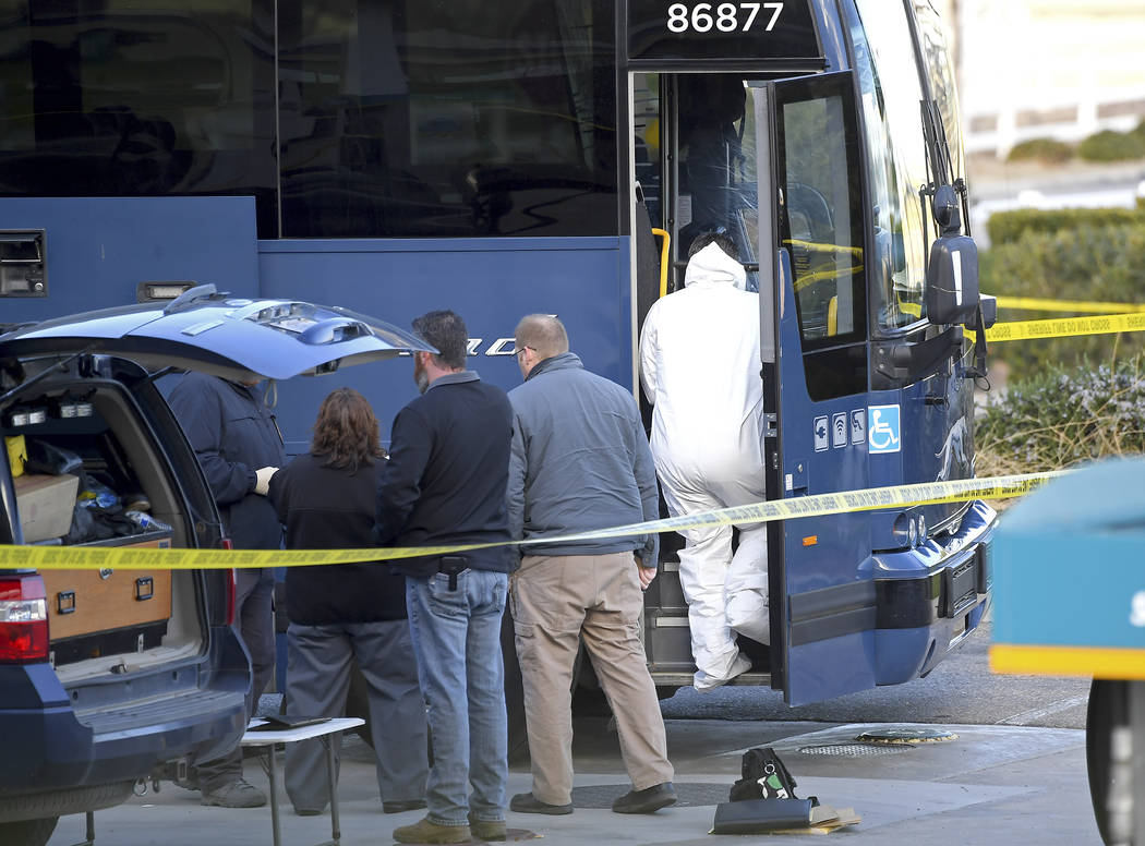 Investigators are seen outside of a Greyhound bus after a passenger was killed on board on Mond ...