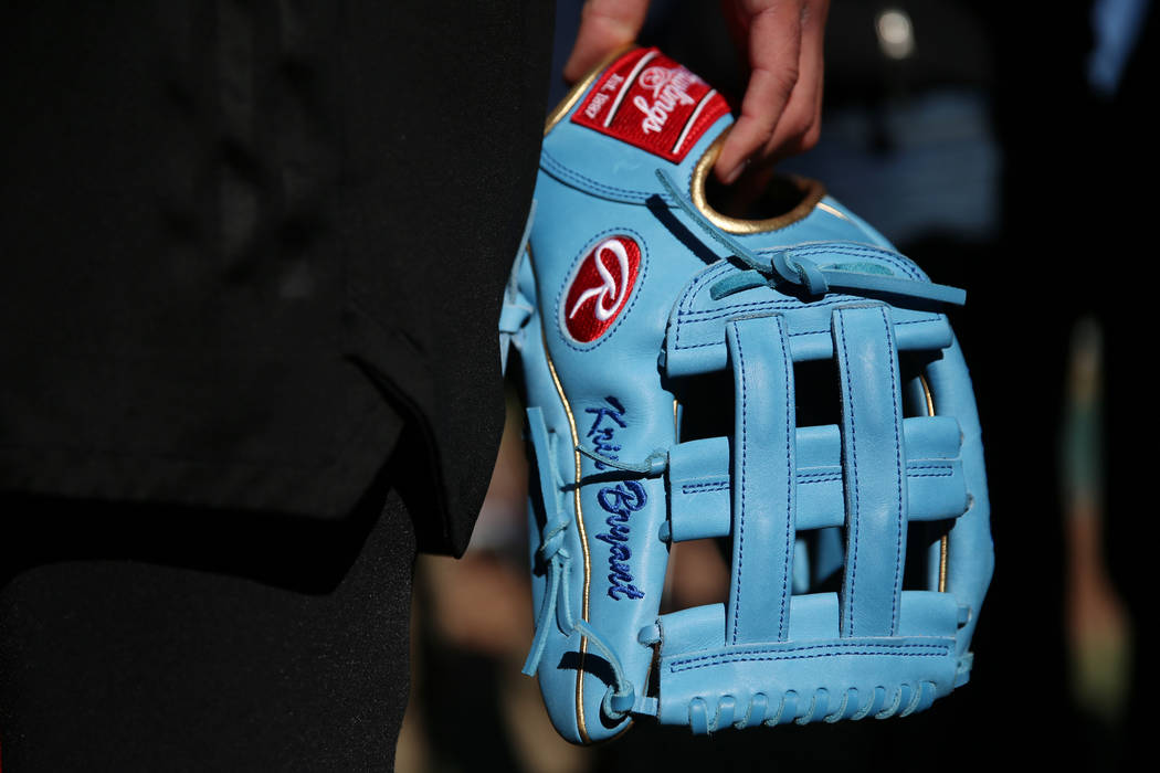 Chicago Cubs player Kris Bryant holds his glove while giving a press interview during a live ba ...