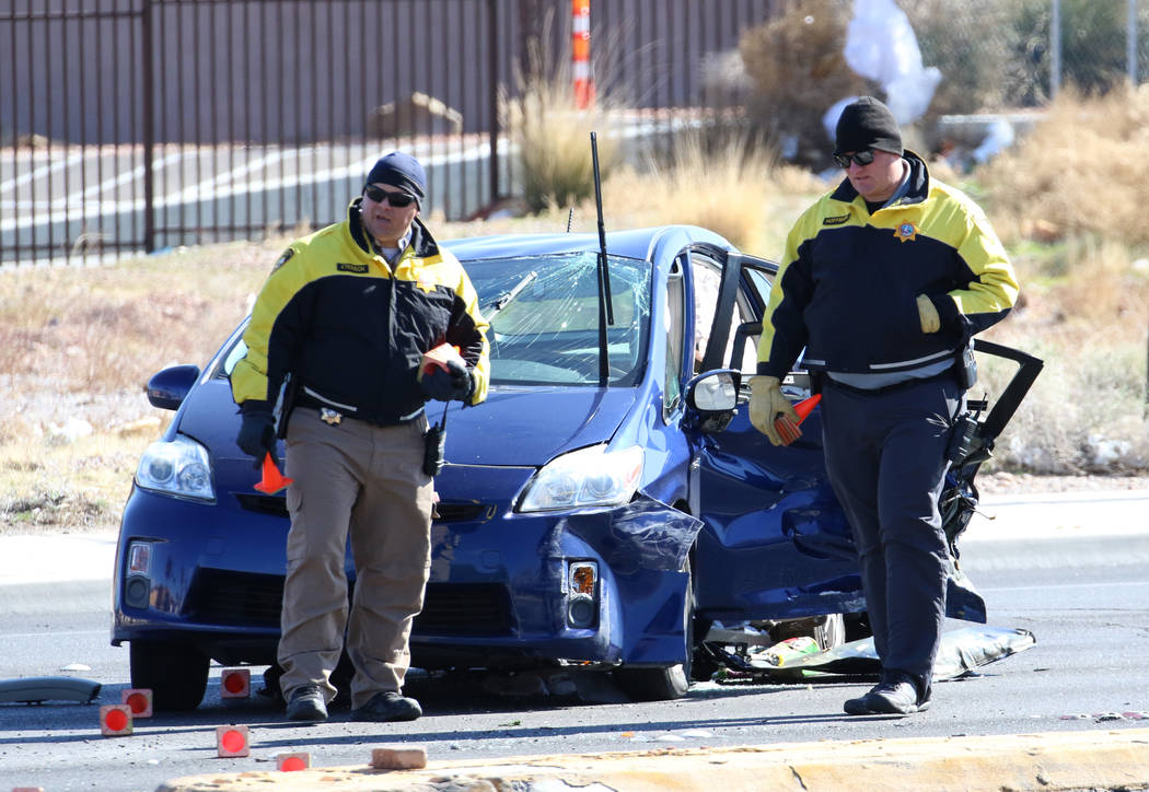 Metropolitan Police Department officers investigate a fatal two-vehicle crash on Rainbow Boulev ...