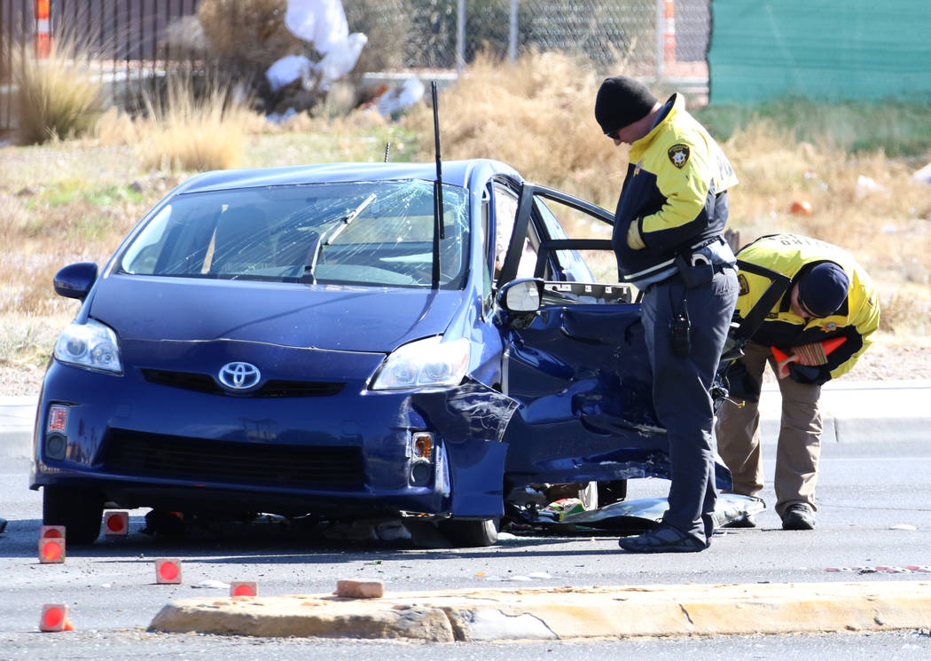 Metropolitan Police Department officers investigate a fatal two-vehicle crash on Rainbow Boulev ...
