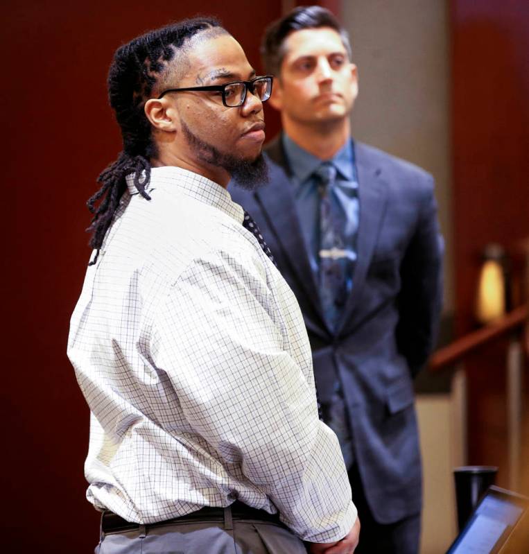 Ray Charles Brown, right, stands as the jury arrives in the courtroom with one of his attorneys ...