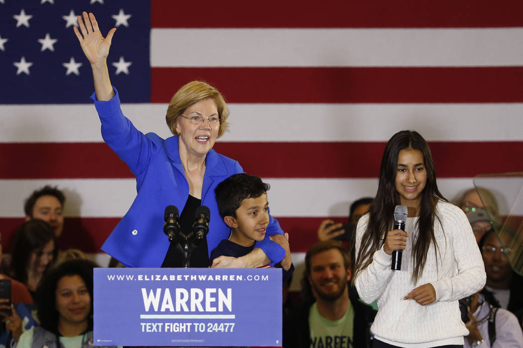 Democratic presidential candidate Sen. Elizabeth Warren, D-Mass., stands with her grandchildren ...