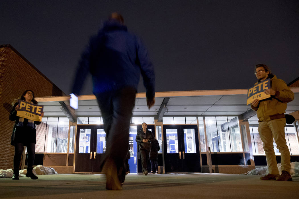 People arrive for caucus at Roosevelt Hight School, Monday, Feb. 3, 2020, in Des Moines, Iowa. ...