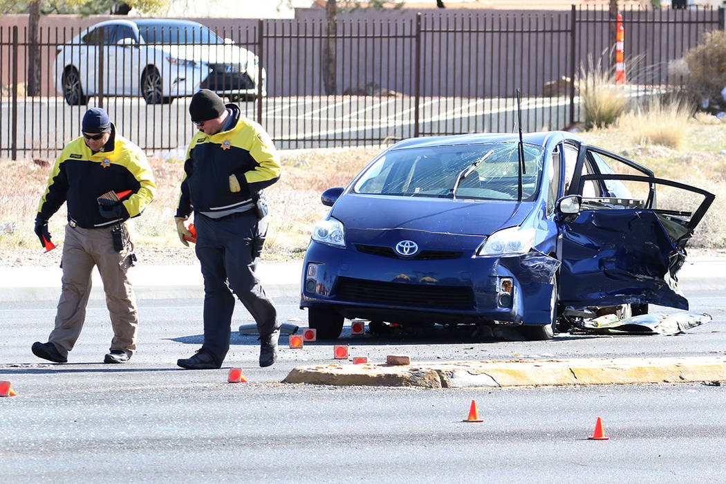 Metropolitan Police Department officers investigate a fatal two-vehicle crash on Rainbow Boulev ...