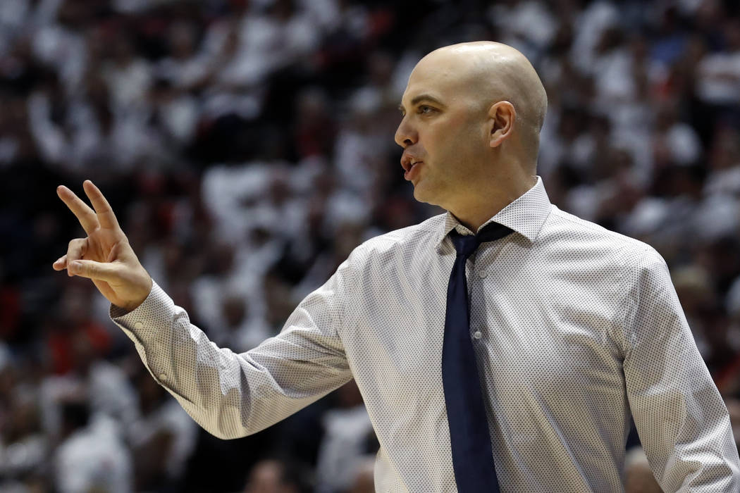 Utah State coach Craig Smith gestures during the first half of the team's NCAA college basketba ...