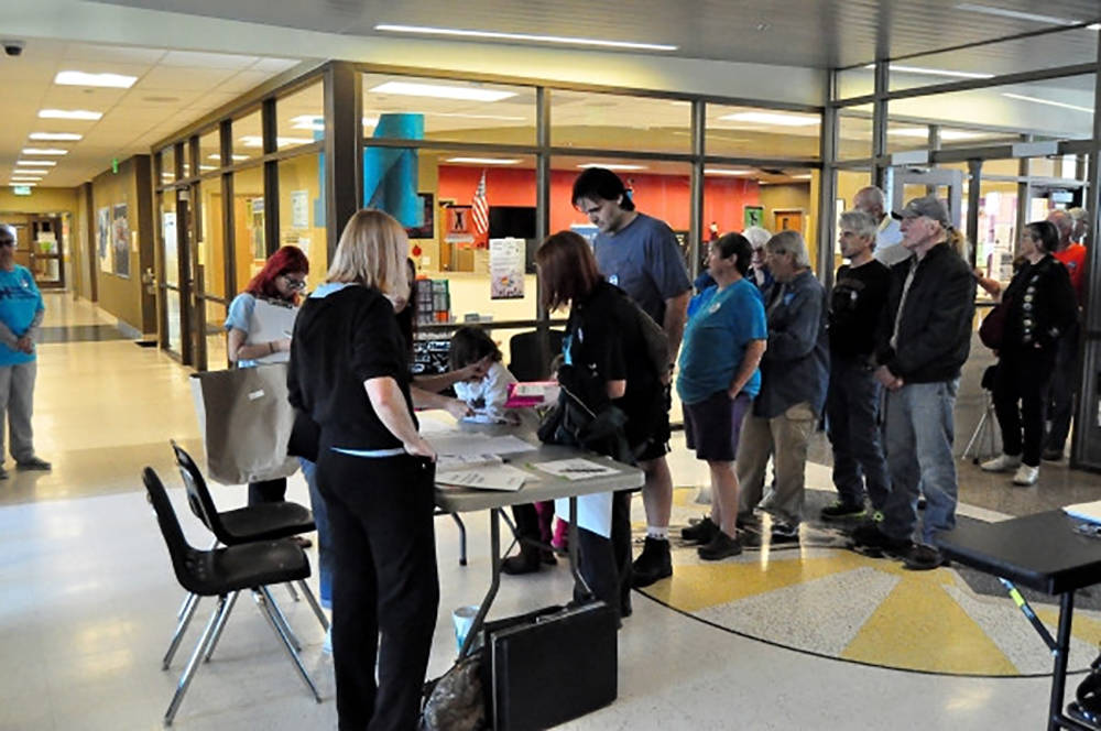 This file photo shows Nevada 2016 Democratic caucus participants signing in on caucus day. (Spe ...