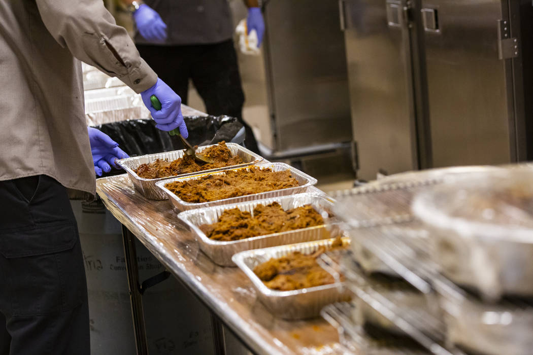 Bob Ayouba, of Three Square food bank, packages beef brisket and other surplus banquet food fro ...